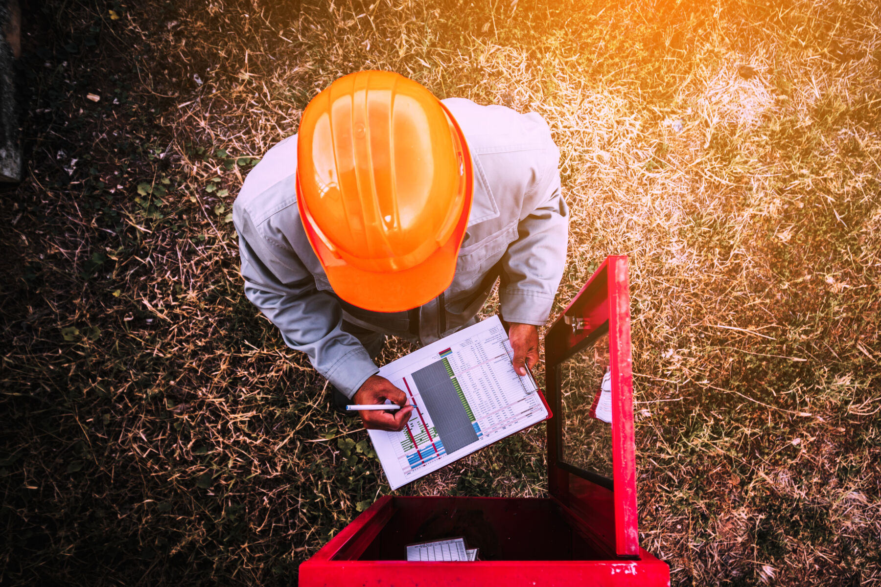 safety officer working on checking Fire extinguisher at outdoor plant